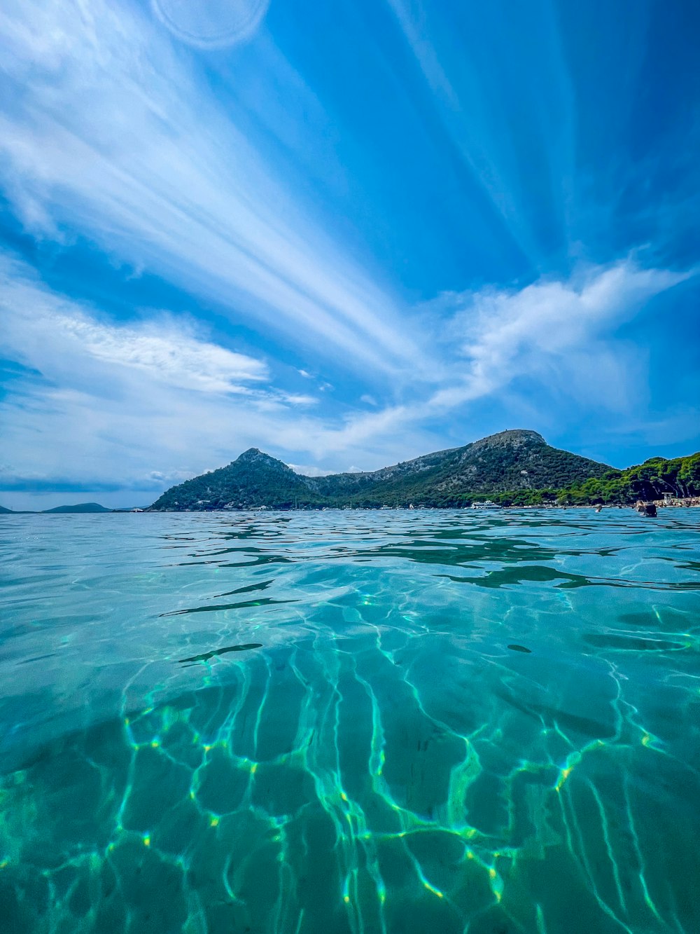 a body of water with a small island in the distance