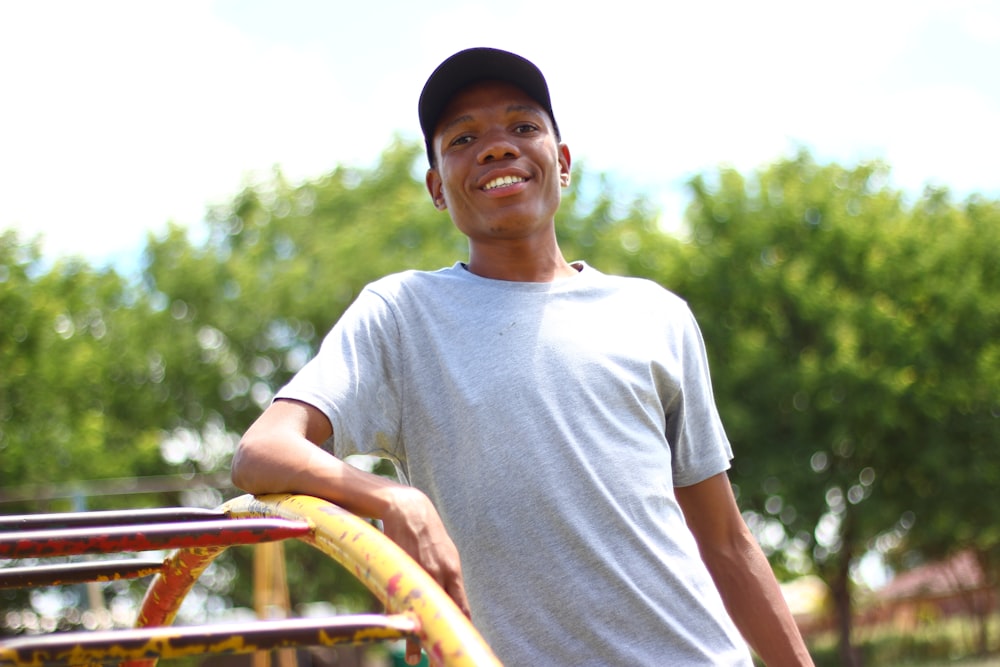 a young man standing next to a yellow frisbee