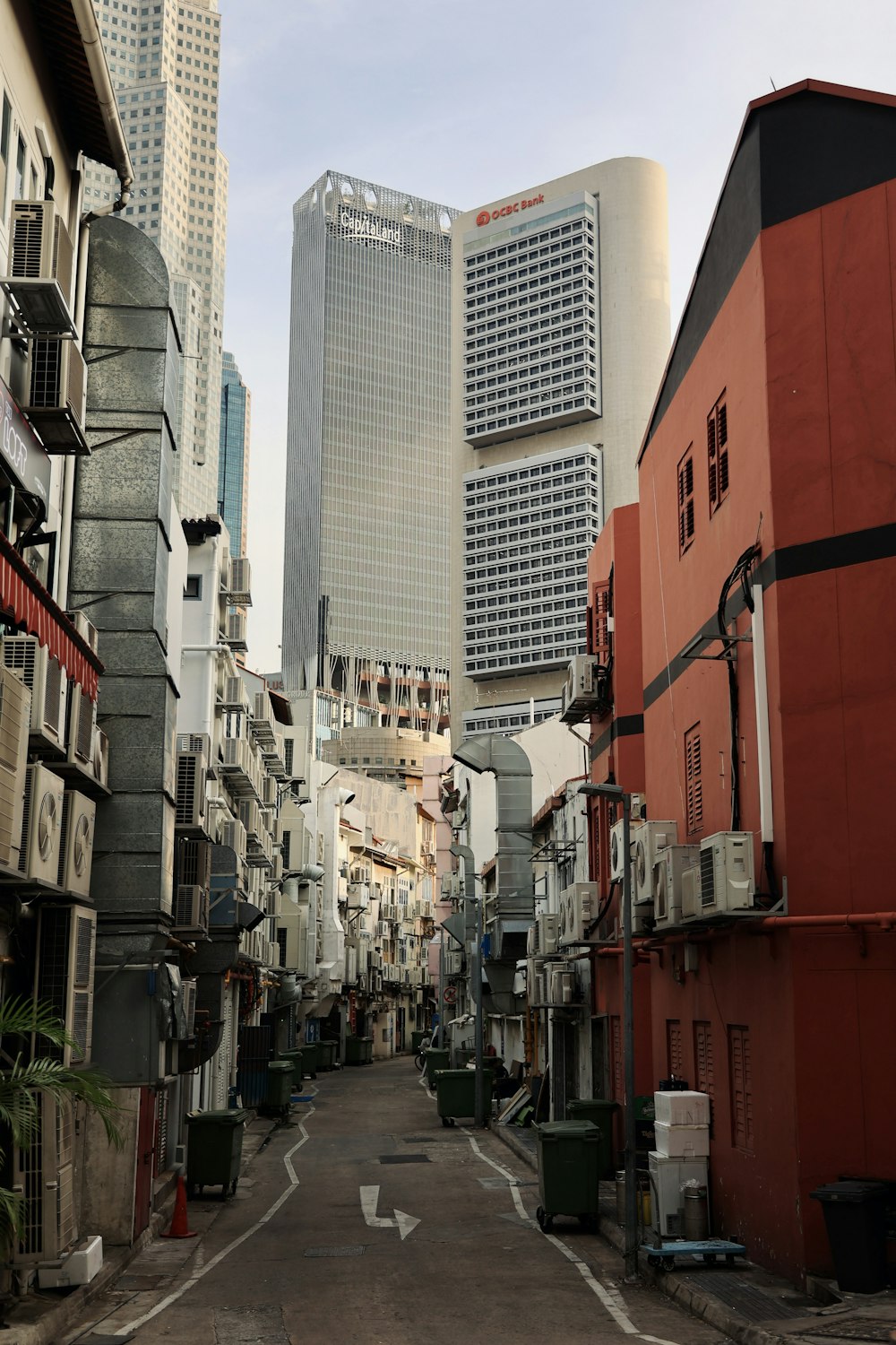 a narrow city street with tall buildings in the background