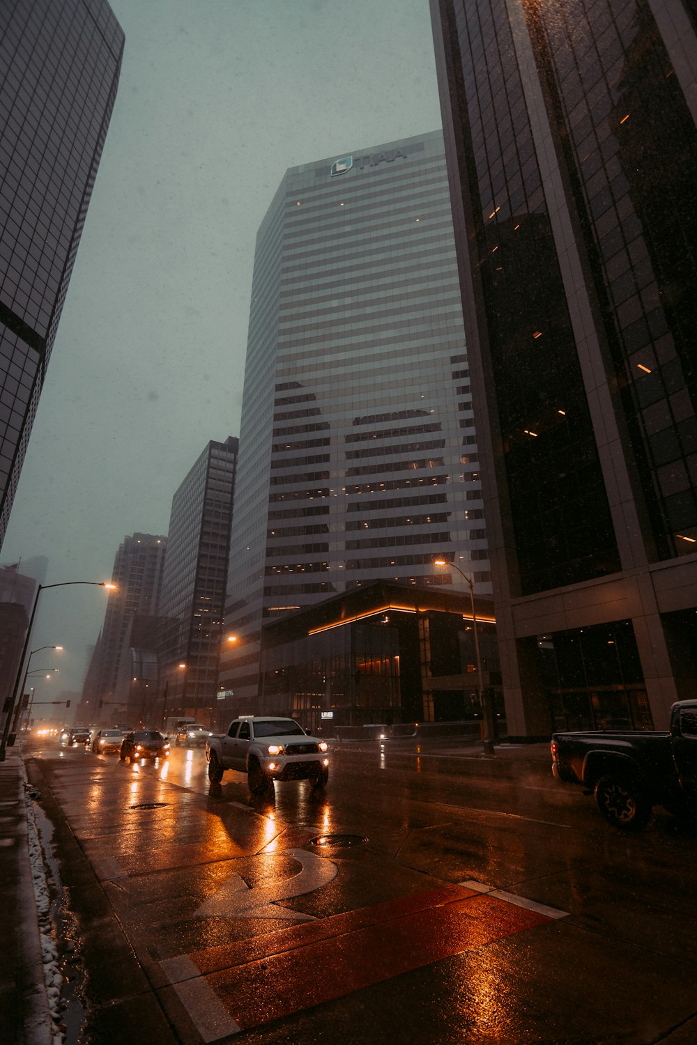 a city street filled with lots of traffic on a rainy day