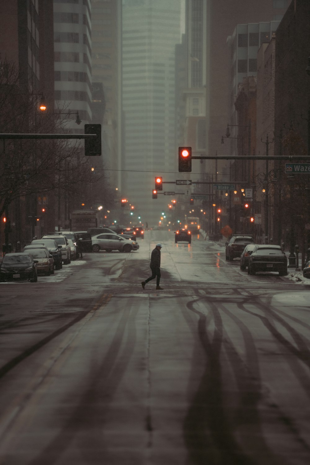 a person walking down a street in the snow