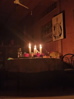 Brightly lit room with traditional spiritual objects and candles glowing softly.