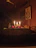 A cozy, dimly lit room with soft candles and BDSM tools neatly arranged on a wooden table.