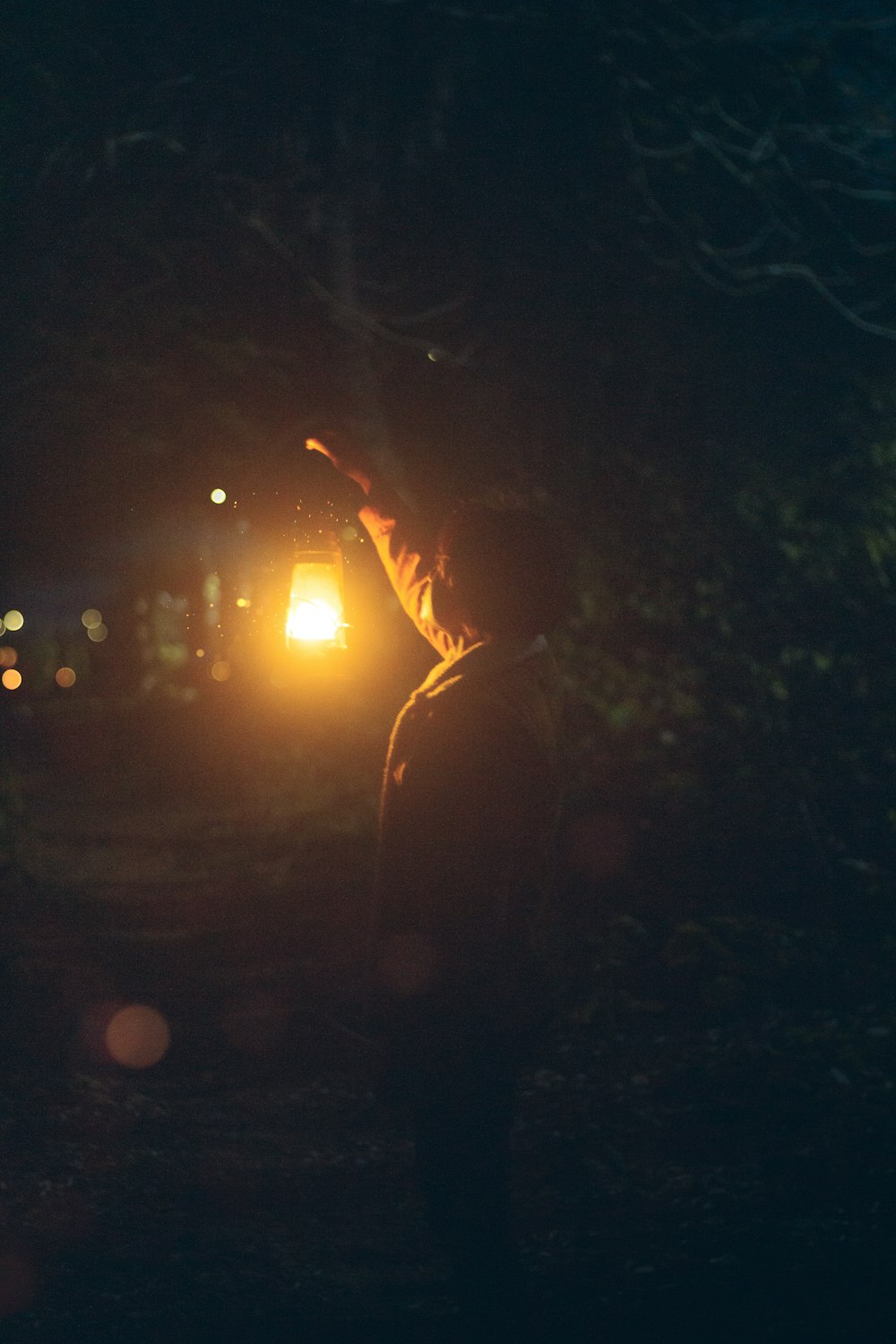 a person holding a light in the dark