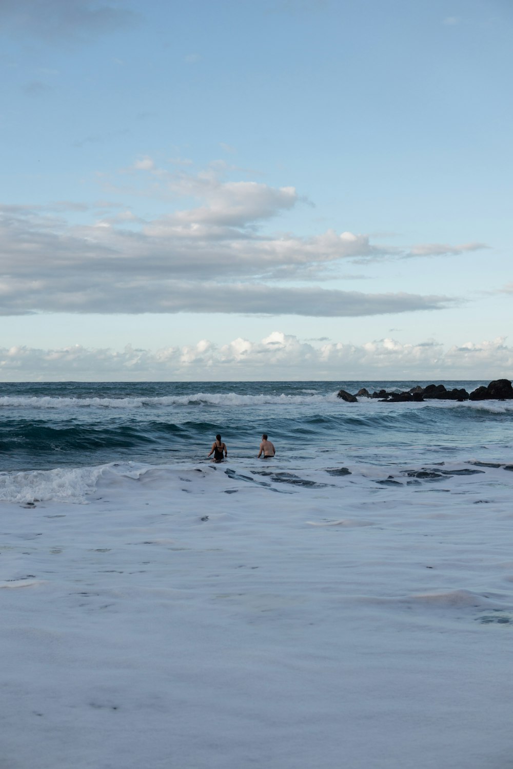 a couple of people are in the ocean