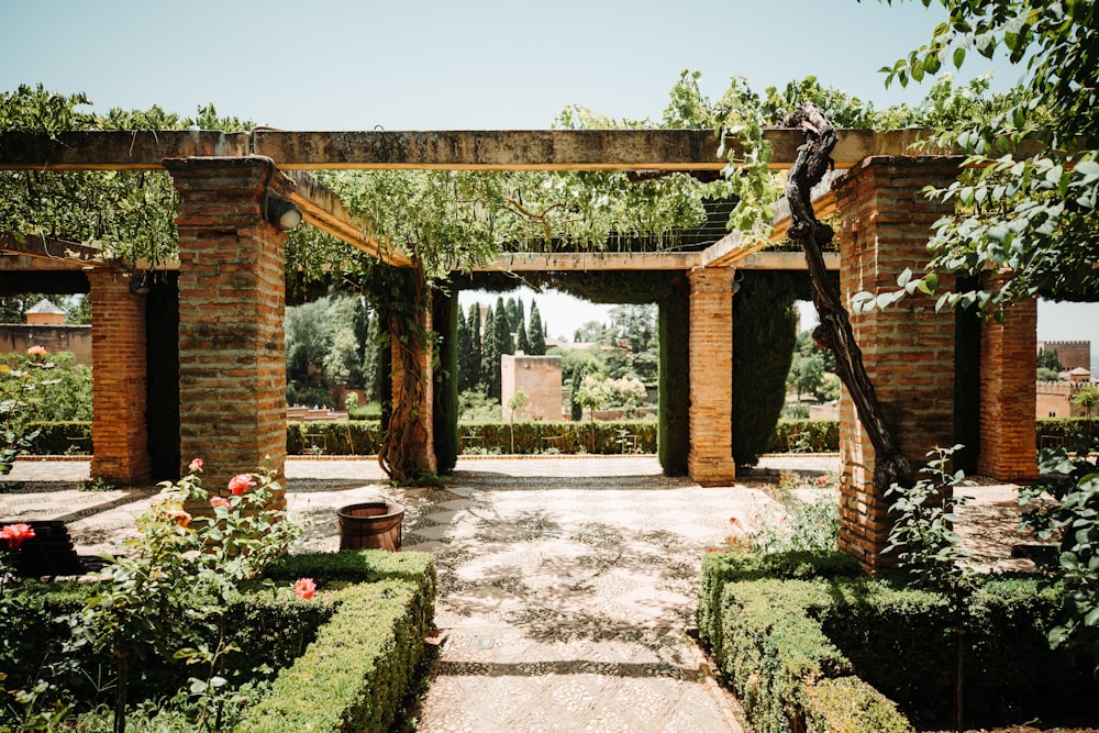 a garden with a stone walkway surrounded by greenery