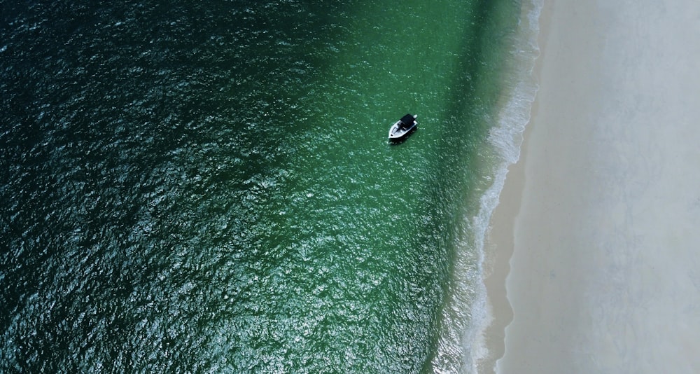 an aerial view of a boat in the ocean