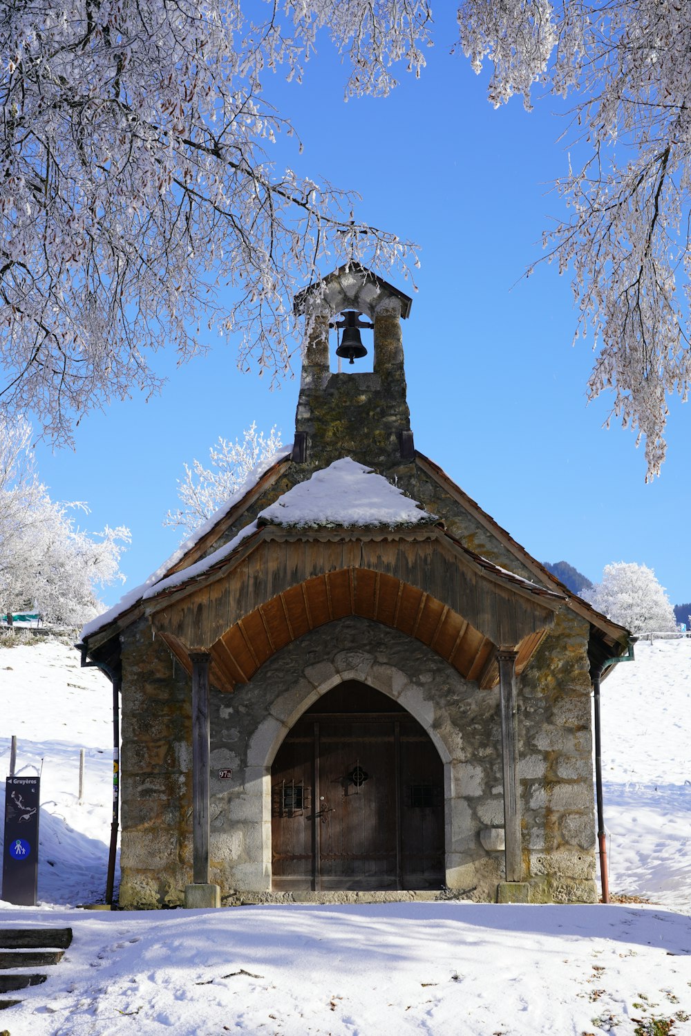 a small church with a bell on top of it