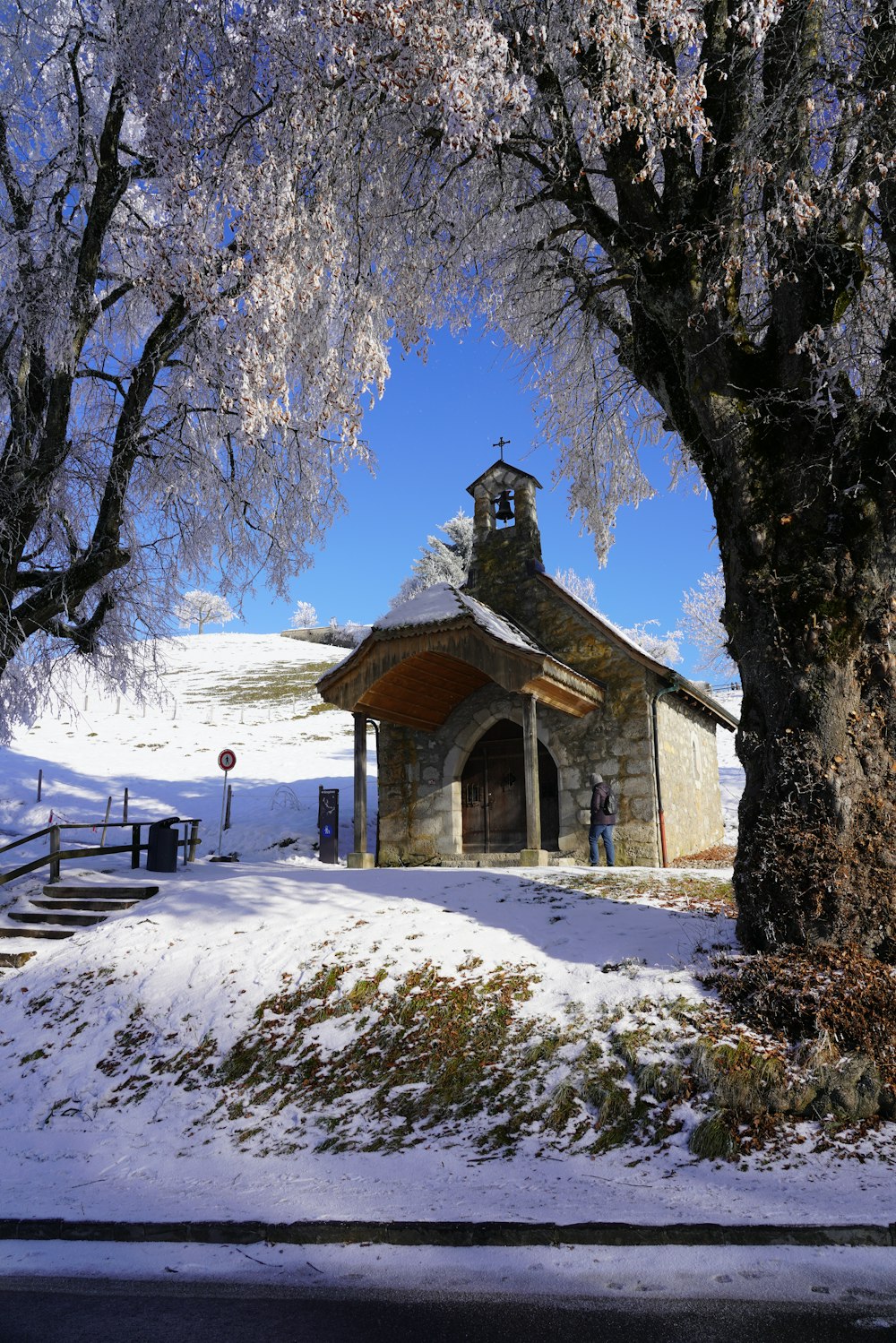 a small church in the middle of a snowy field