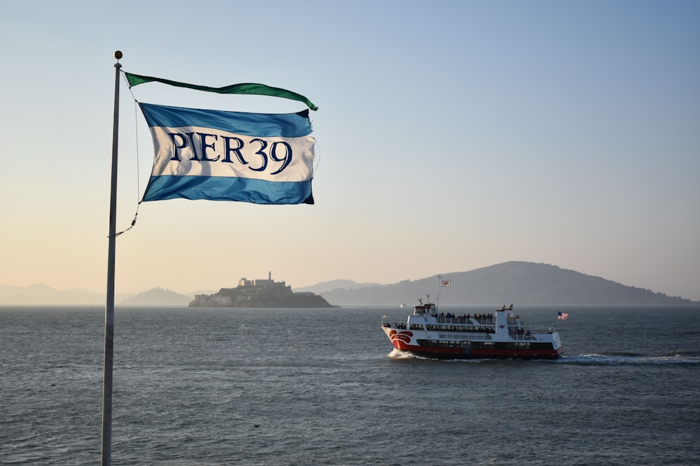 a boat in the water with a flag on it