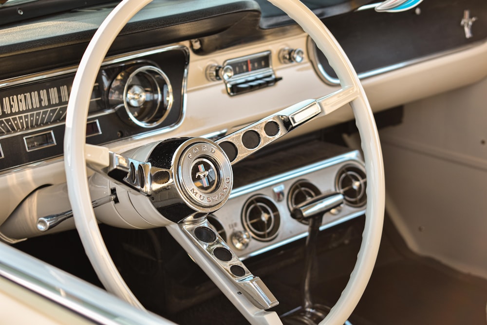 the interior of a car with a steering wheel and dashboard