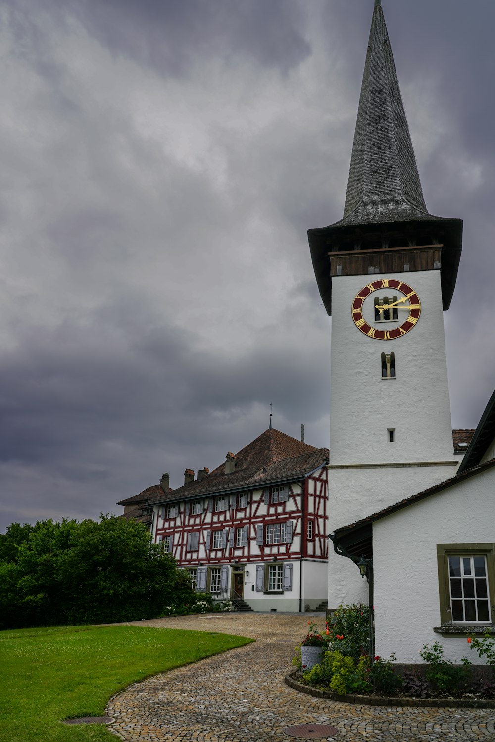 a white building with a clock on the side of it