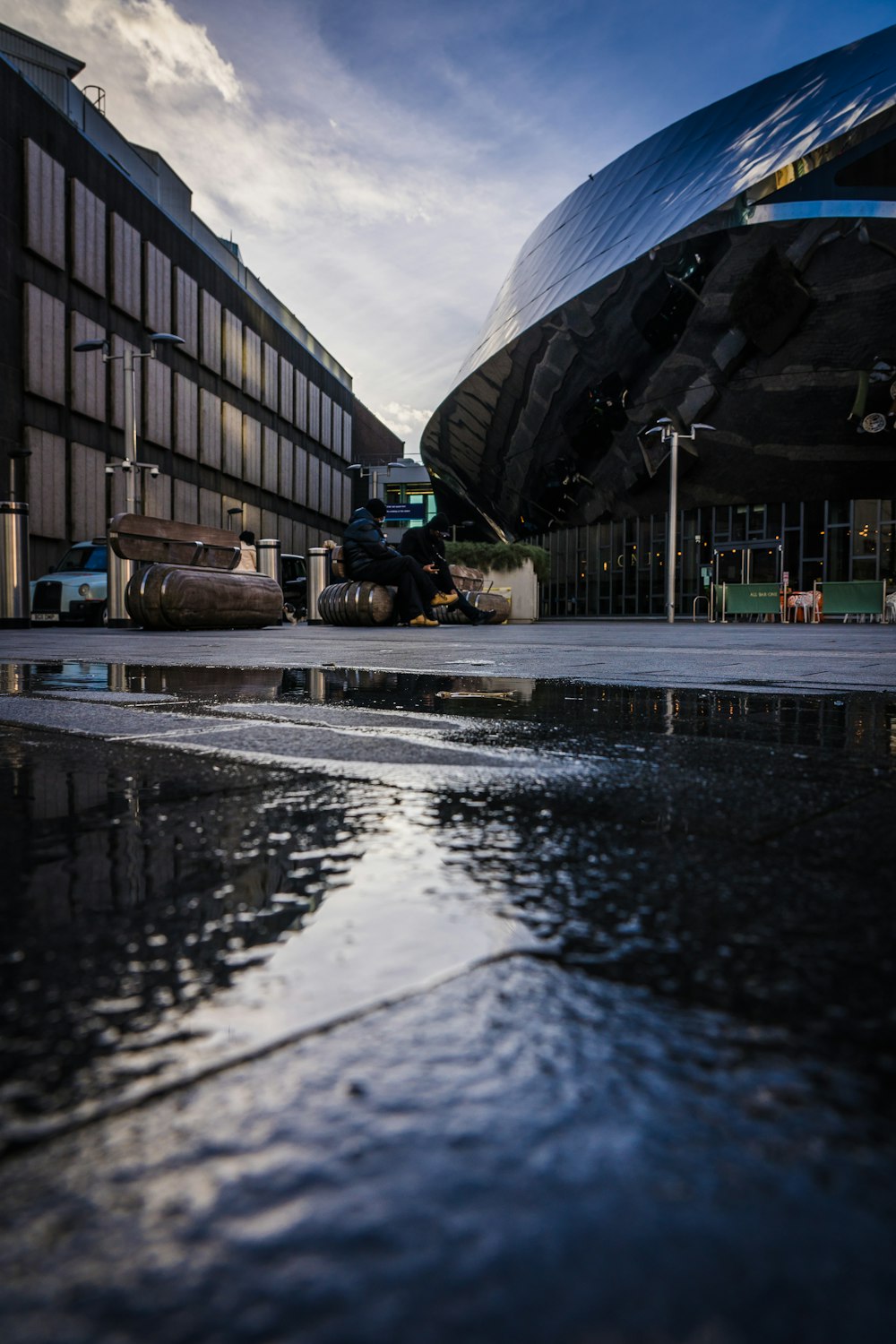 a puddle of water in front of a building