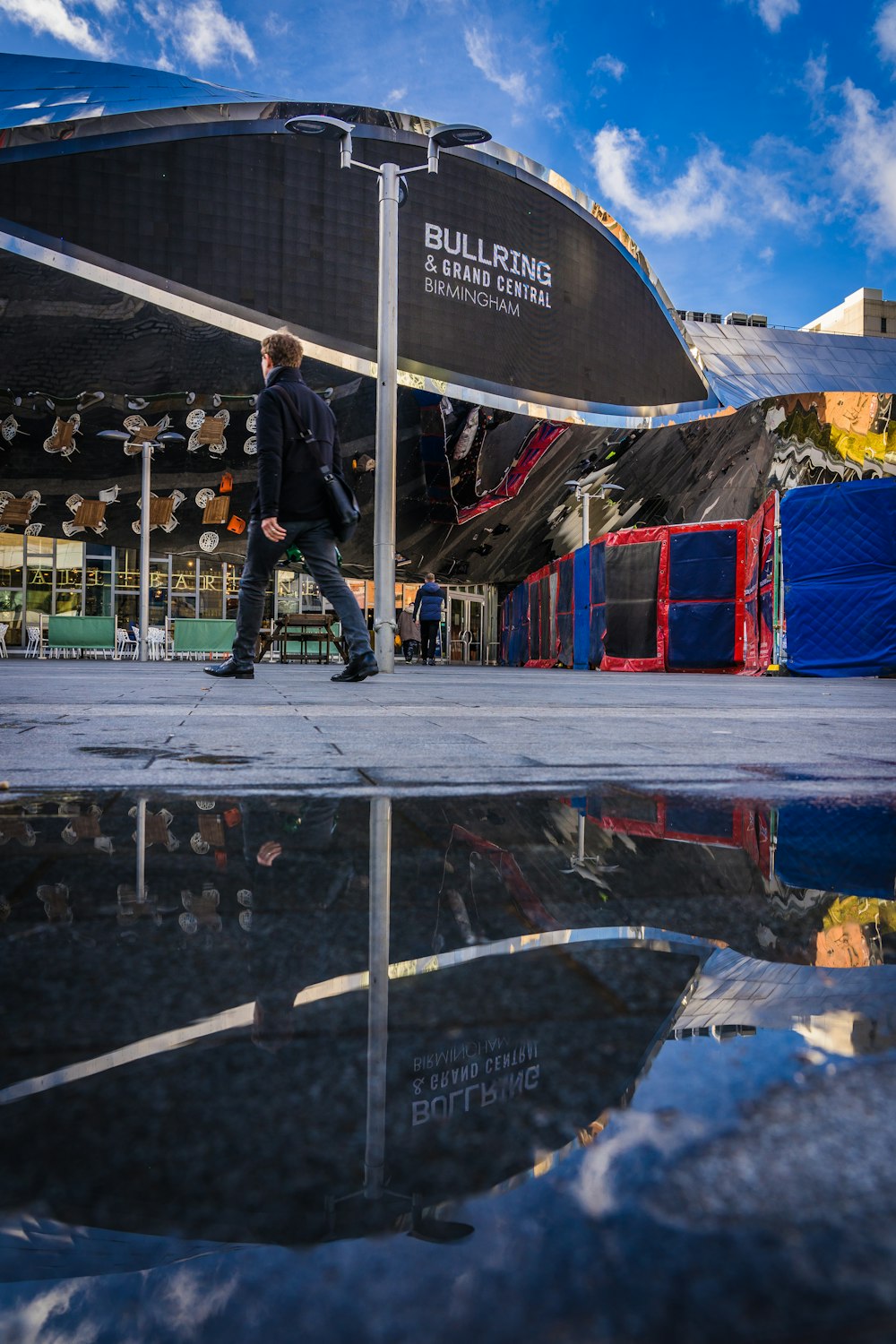 a man walking in front of a building