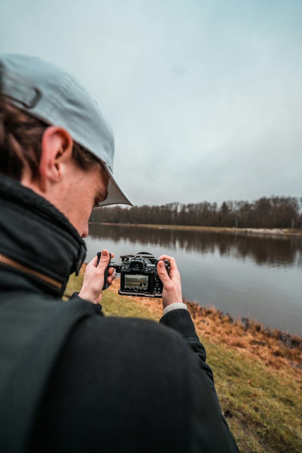 a man taking a picture of a body of water