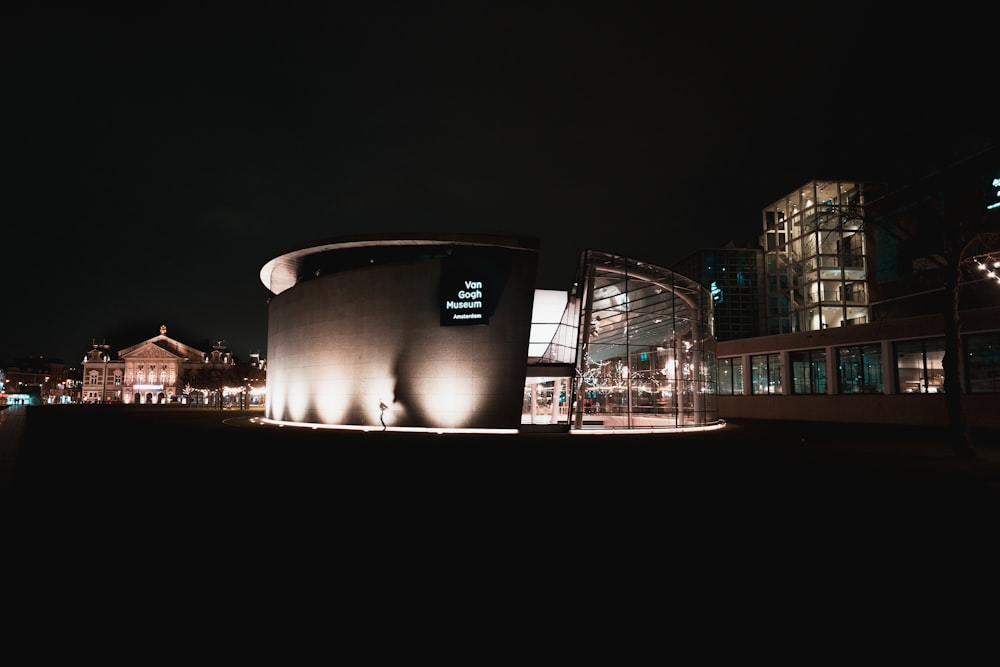 a building lit up at night in a city