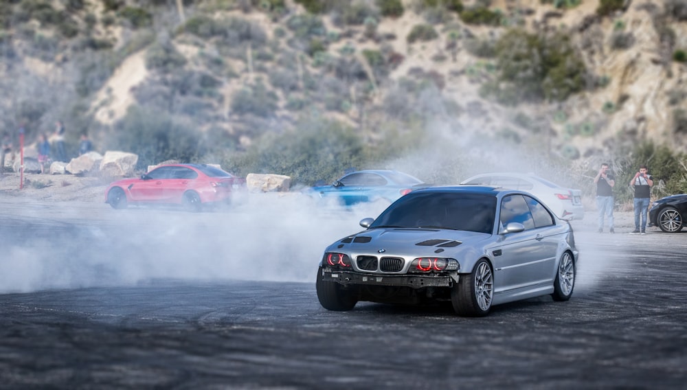 a silver car with smoke coming out of it