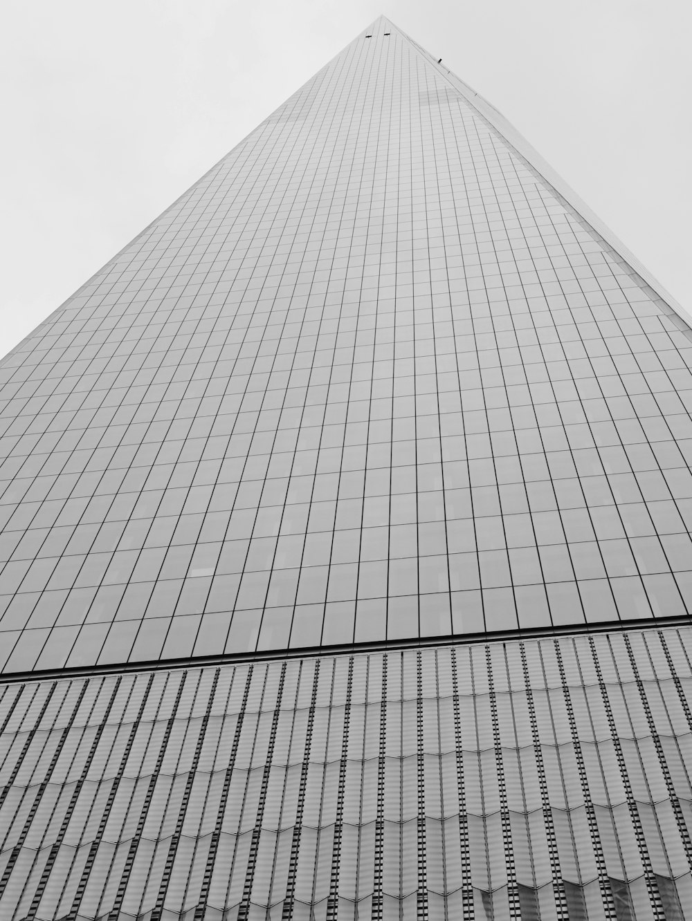 a black and white photo of a very tall building