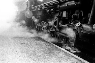 Black and white photo of early engineers working on a stationary steam engine.