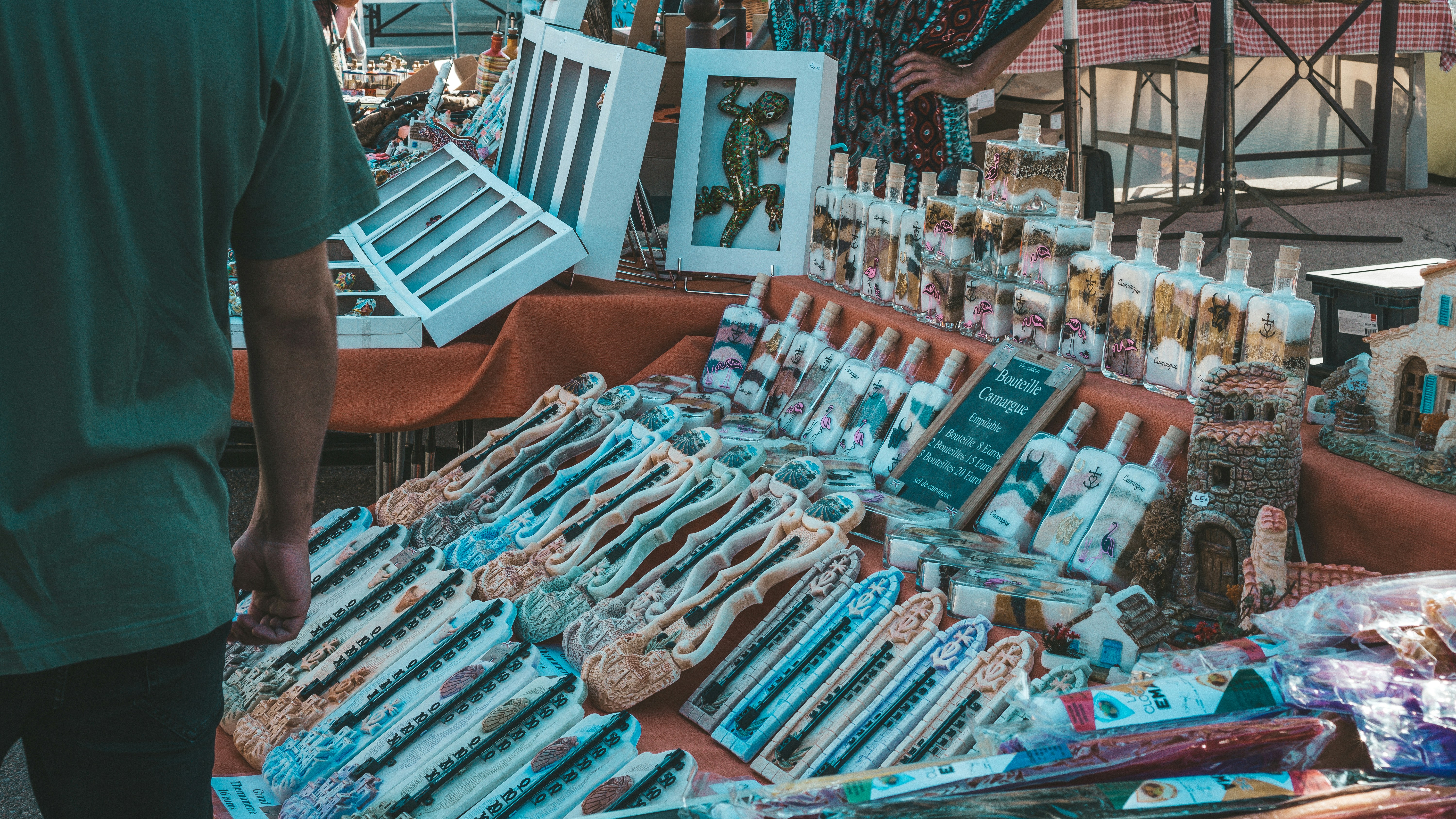 a man standing in front of a table filled with items