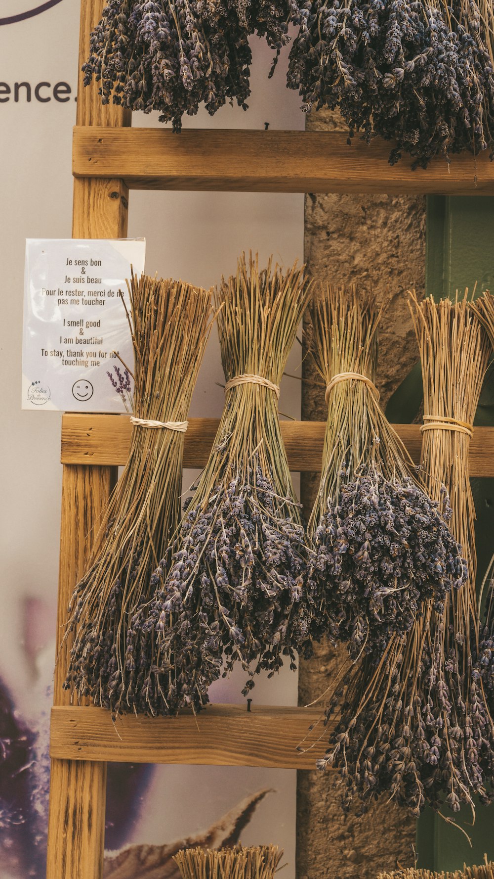 a display of dried lavenders on a wooden shelf