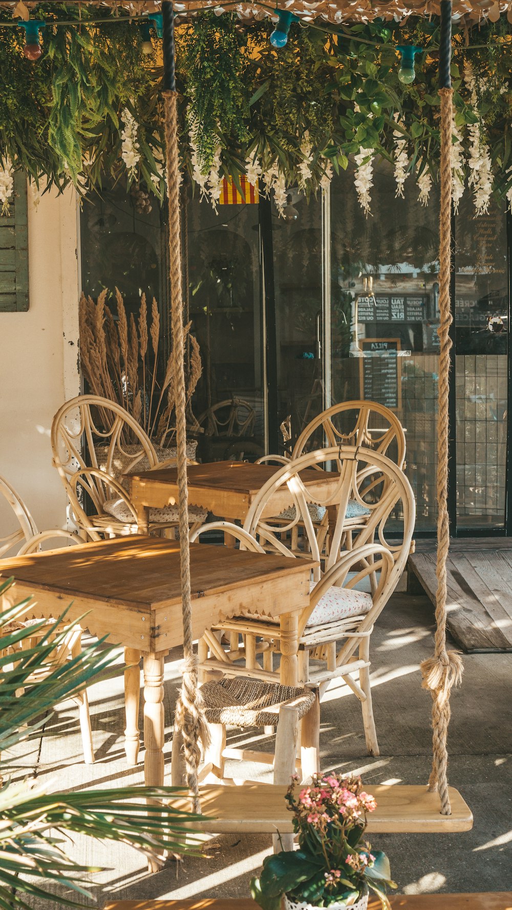 a wooden table and chairs under a canopy