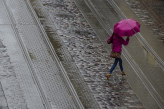 A sleek, lightweight jacket worn by a person walking through a rainy city street, looking comfortable and dry.