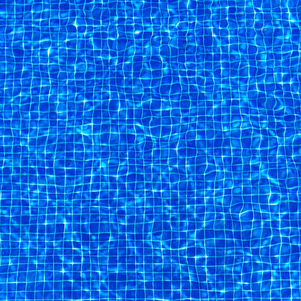 a blue swimming pool with water ripples