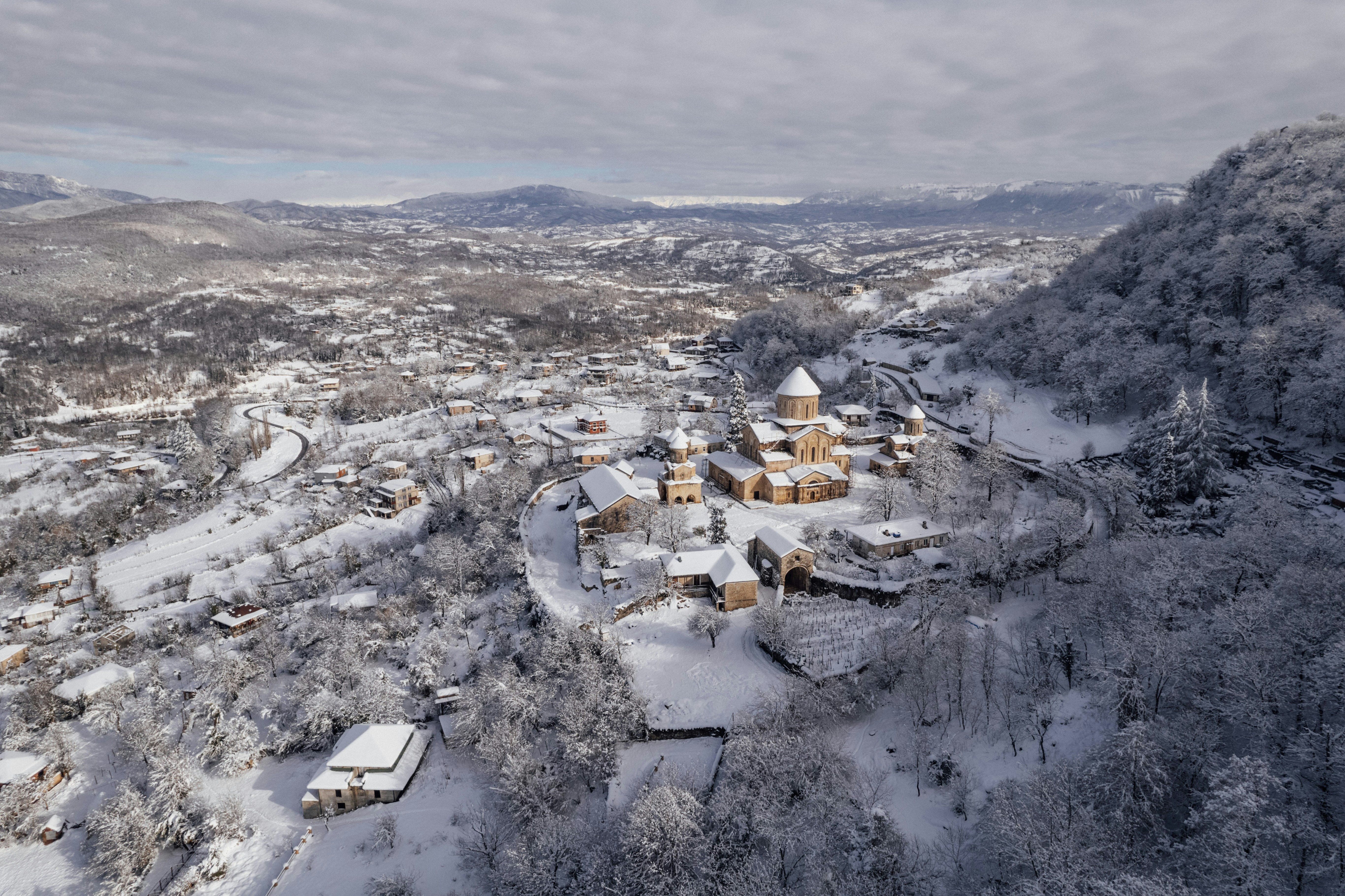 an aerial view of a snow covered village