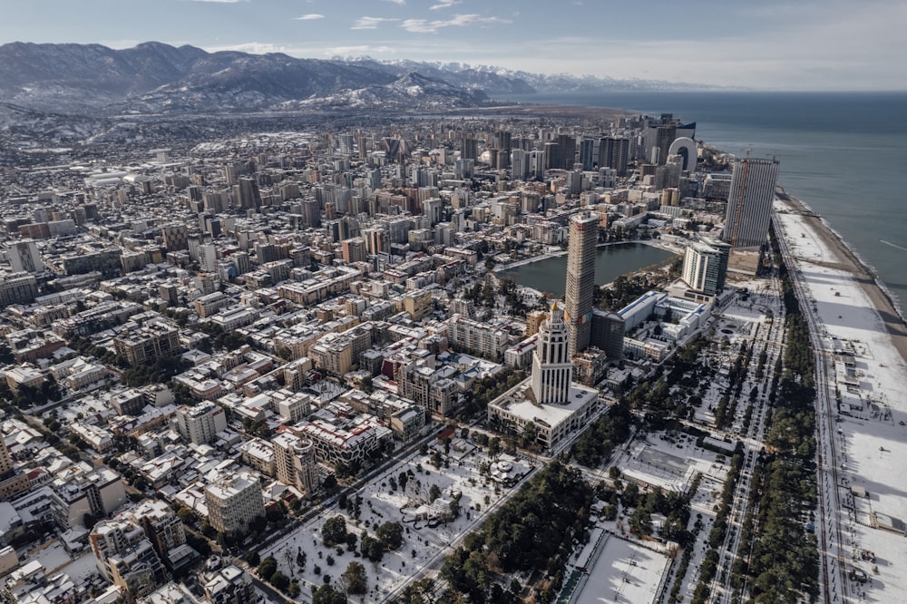 an aerial view of a city with mountains in the background