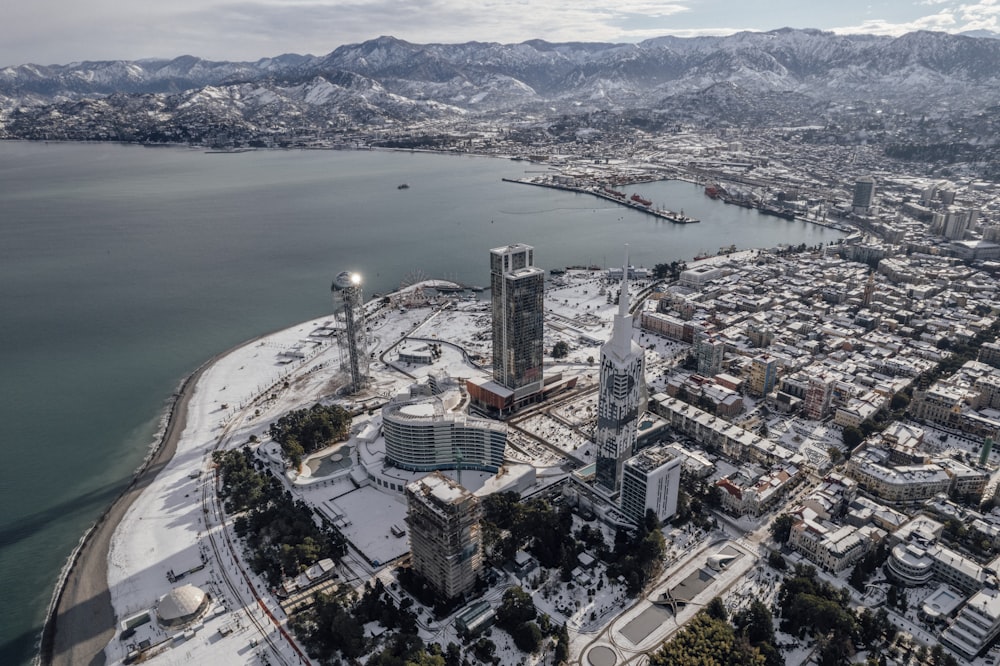 an aerial view of a city with mountains in the background