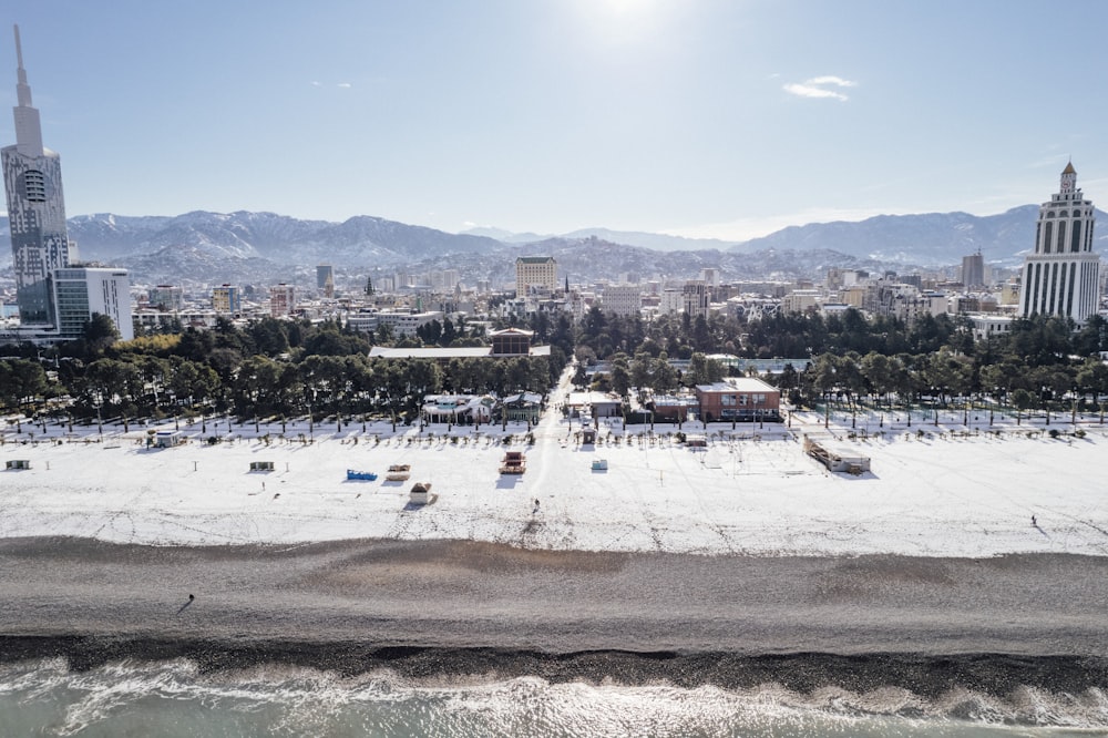 an aerial view of a beach with a city in the background