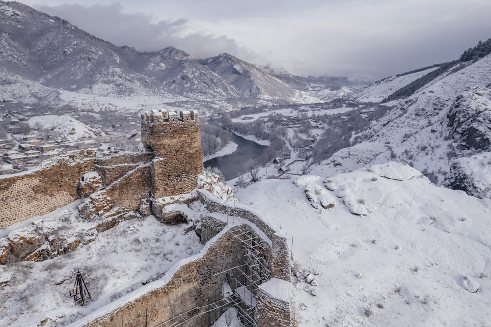 a castle in the middle of a snowy mountain