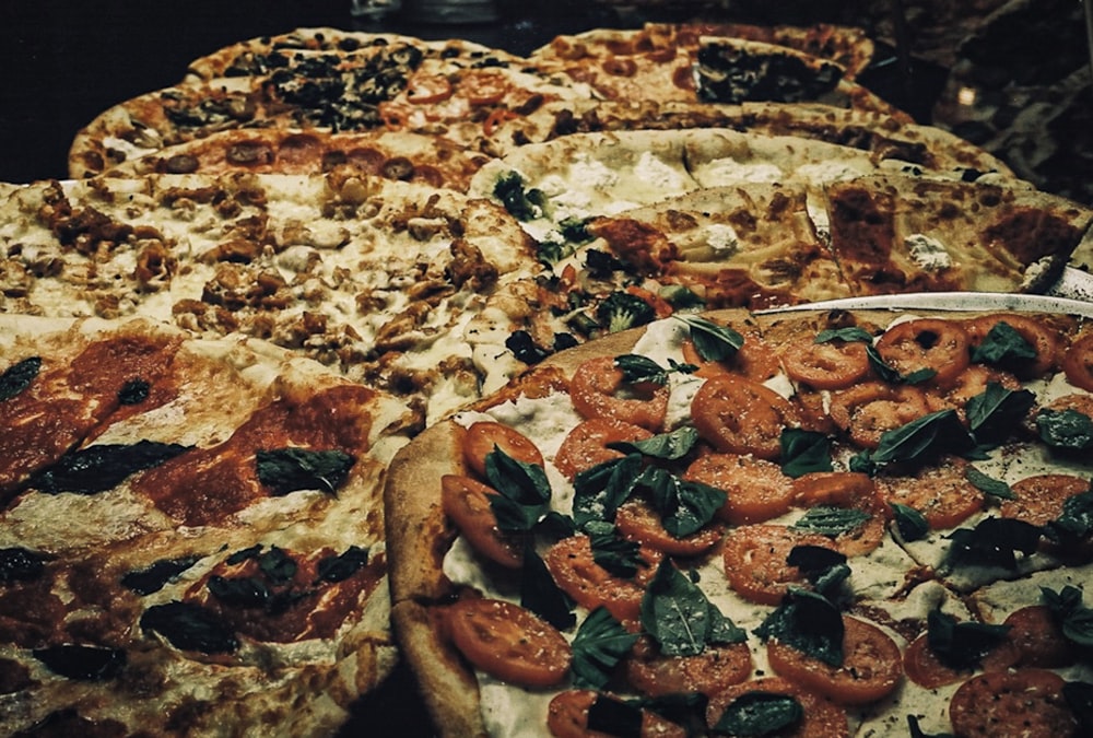 a close up of several pizzas on a table