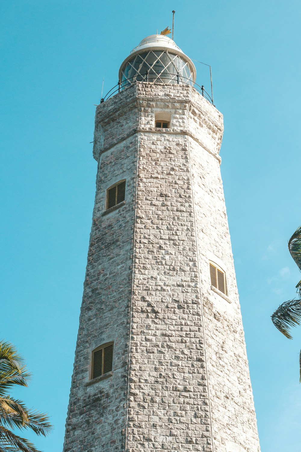 a tall brick tower with a clock on top