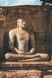 a statue of a person sitting in a lotus position