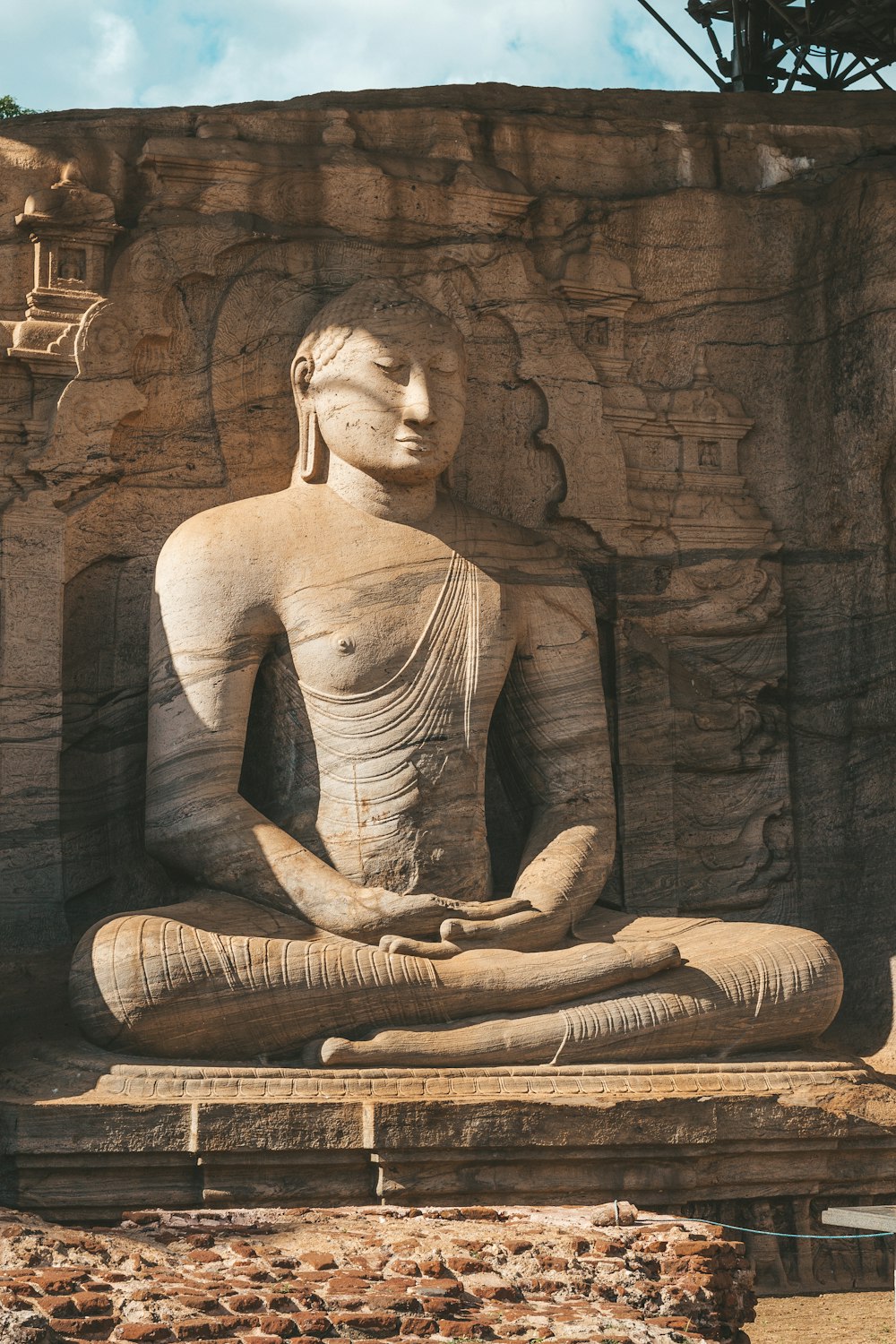 a statue of a person sitting in a lotus position