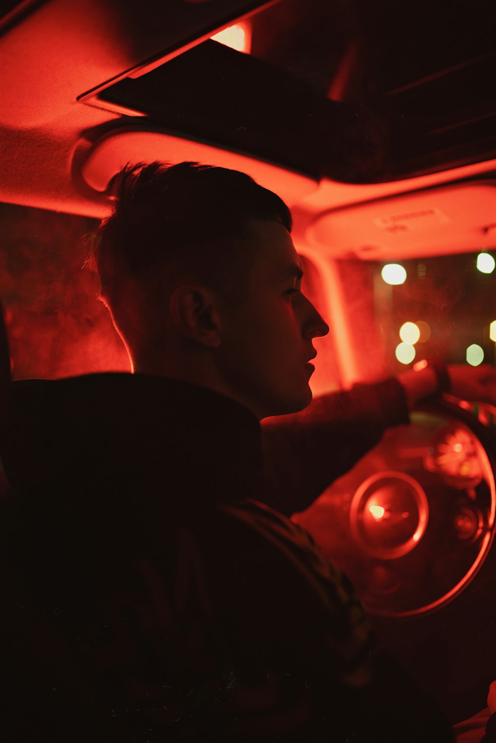 a man driving a car in the dark