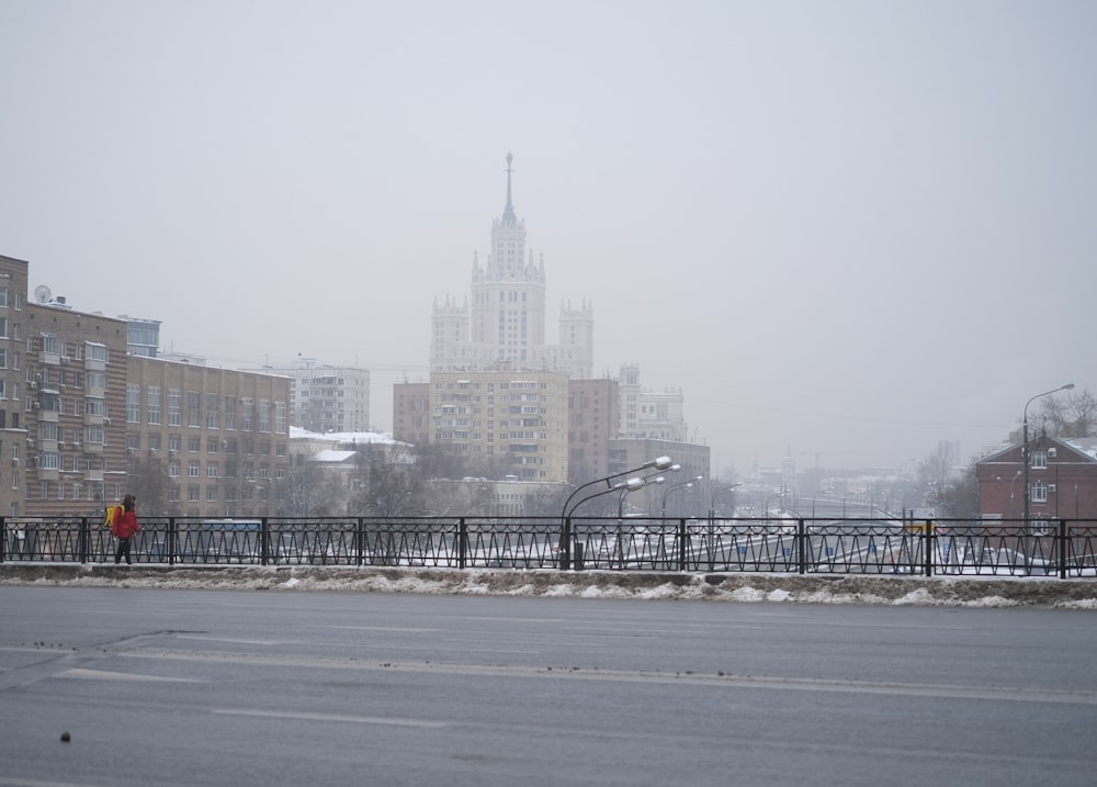 a person walking across a bridge in the snow