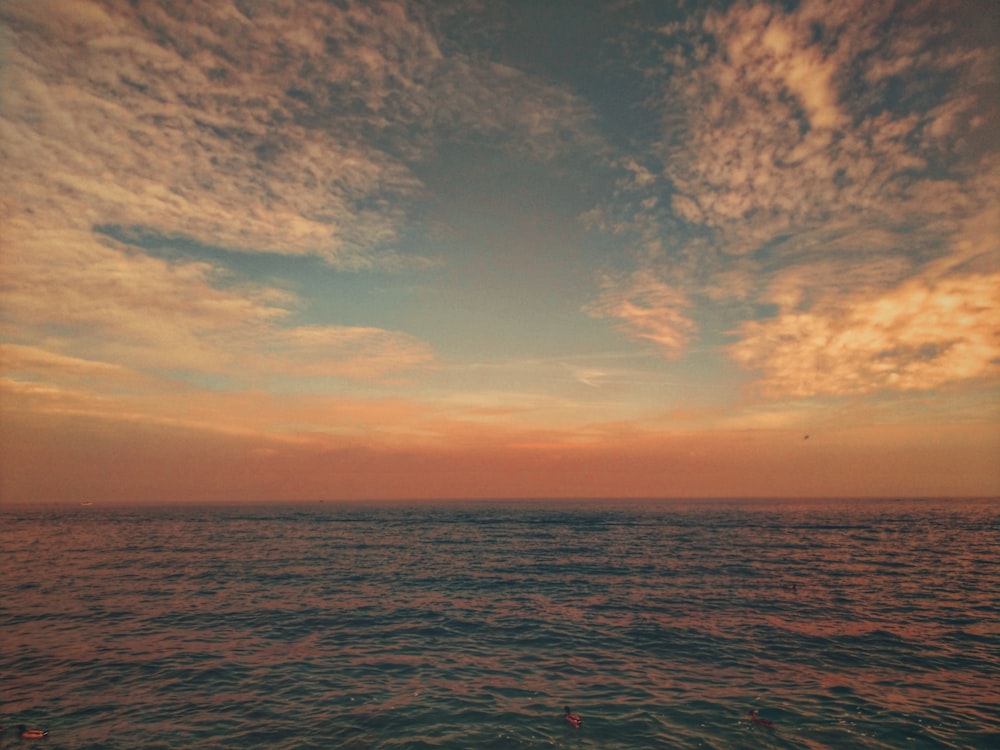 a view of the ocean at sunset from a boat