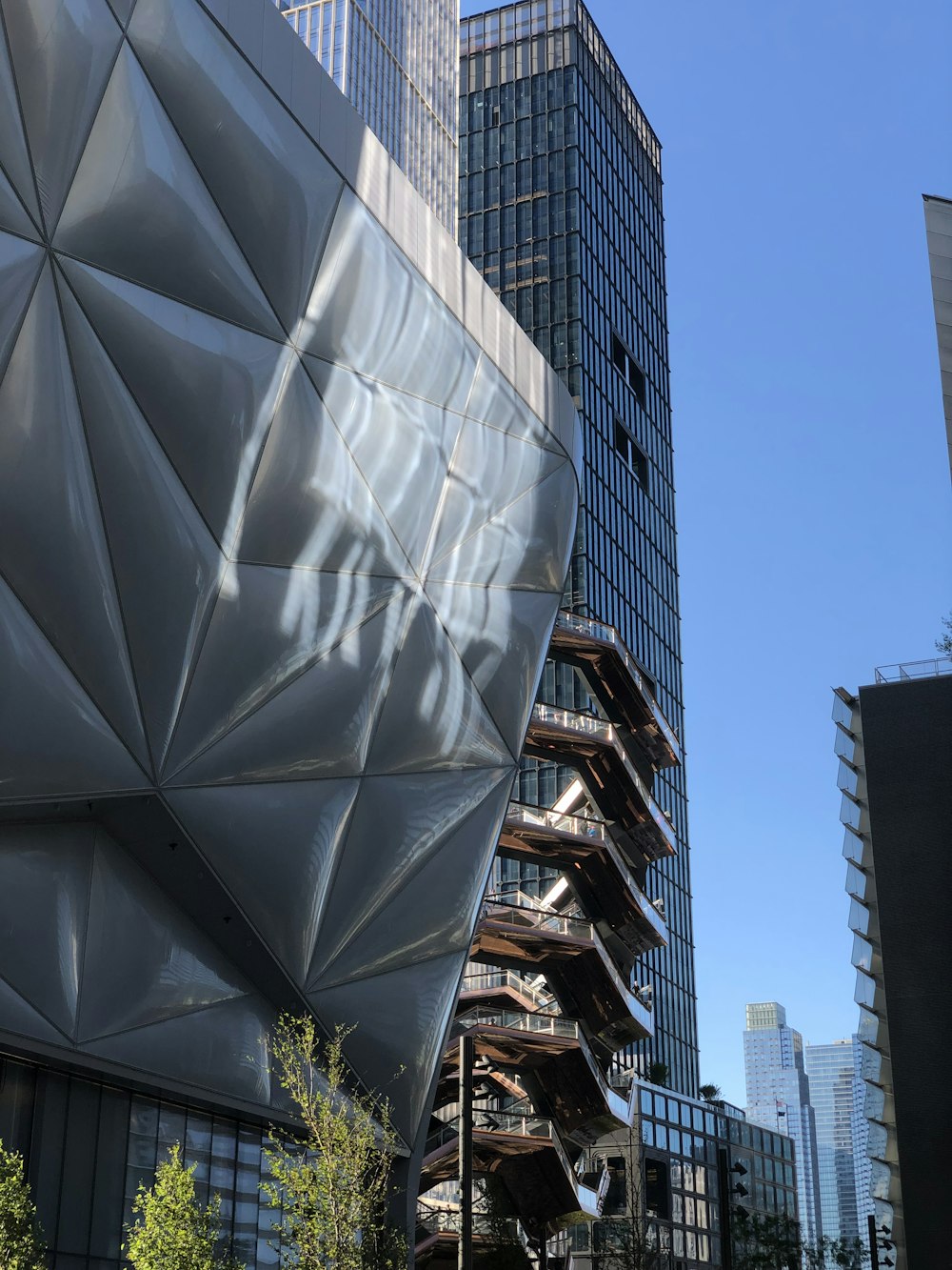 a tall building with a metal structure in front of it