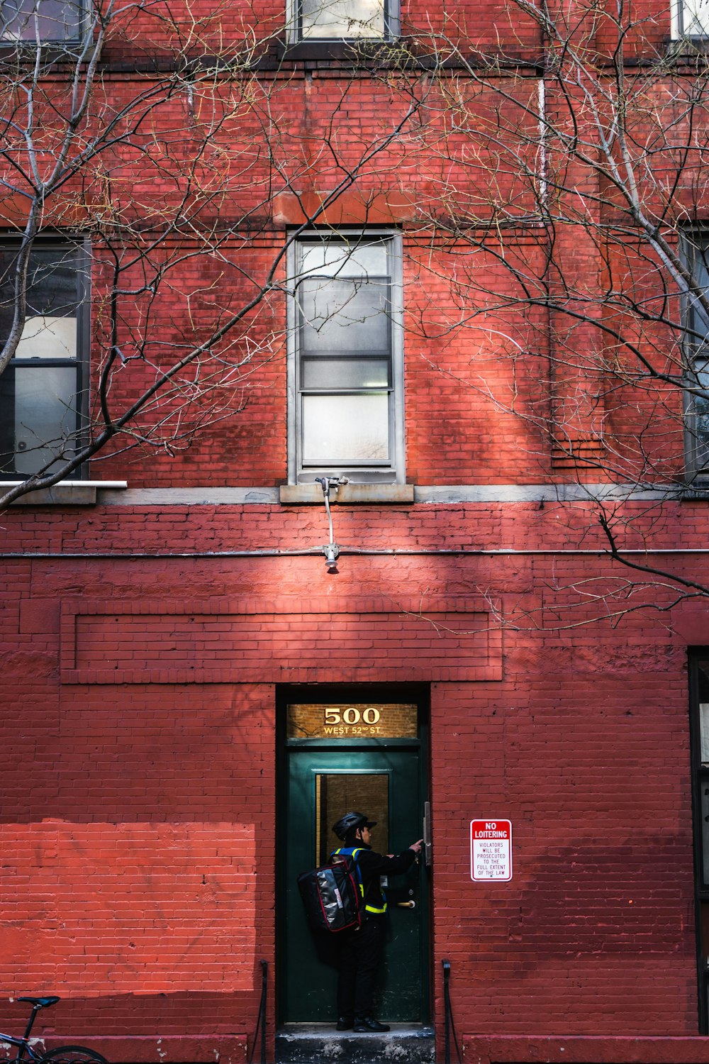 a red brick building with a bicycle parked in front of it