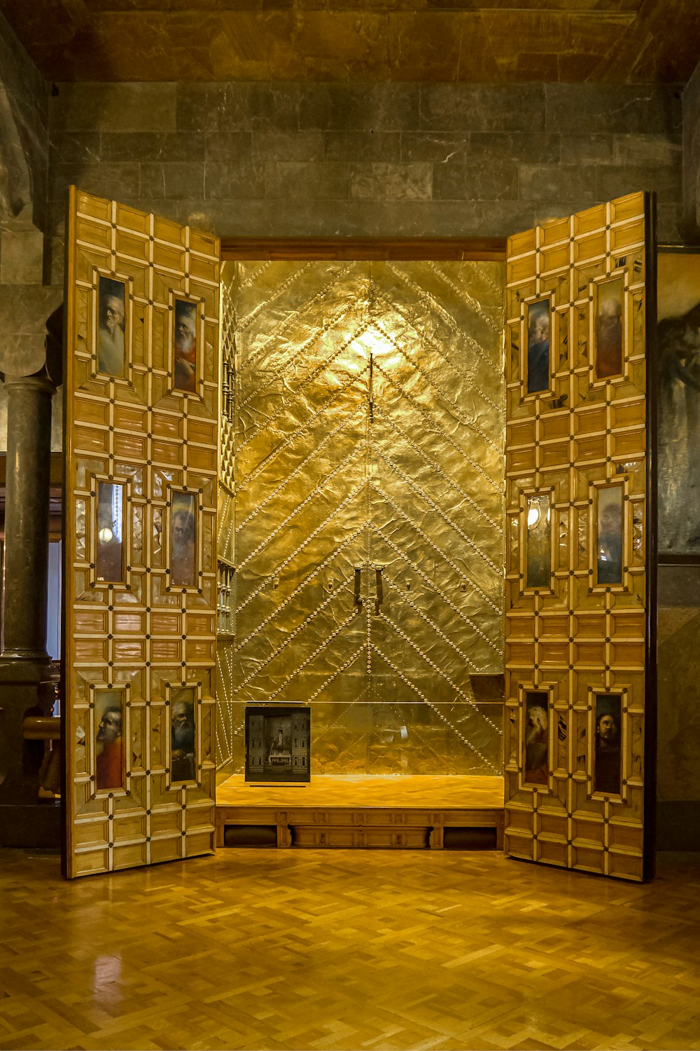 a room with a golden wall and a wooden bench