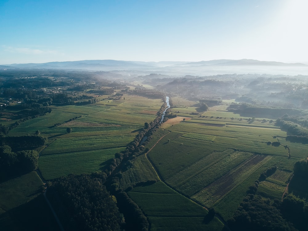 an aerial view of a river running through a lush green countryside