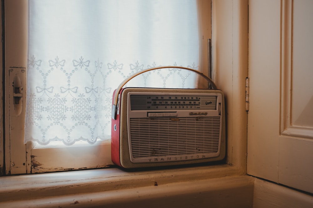 a radio sitting on top of a window sill