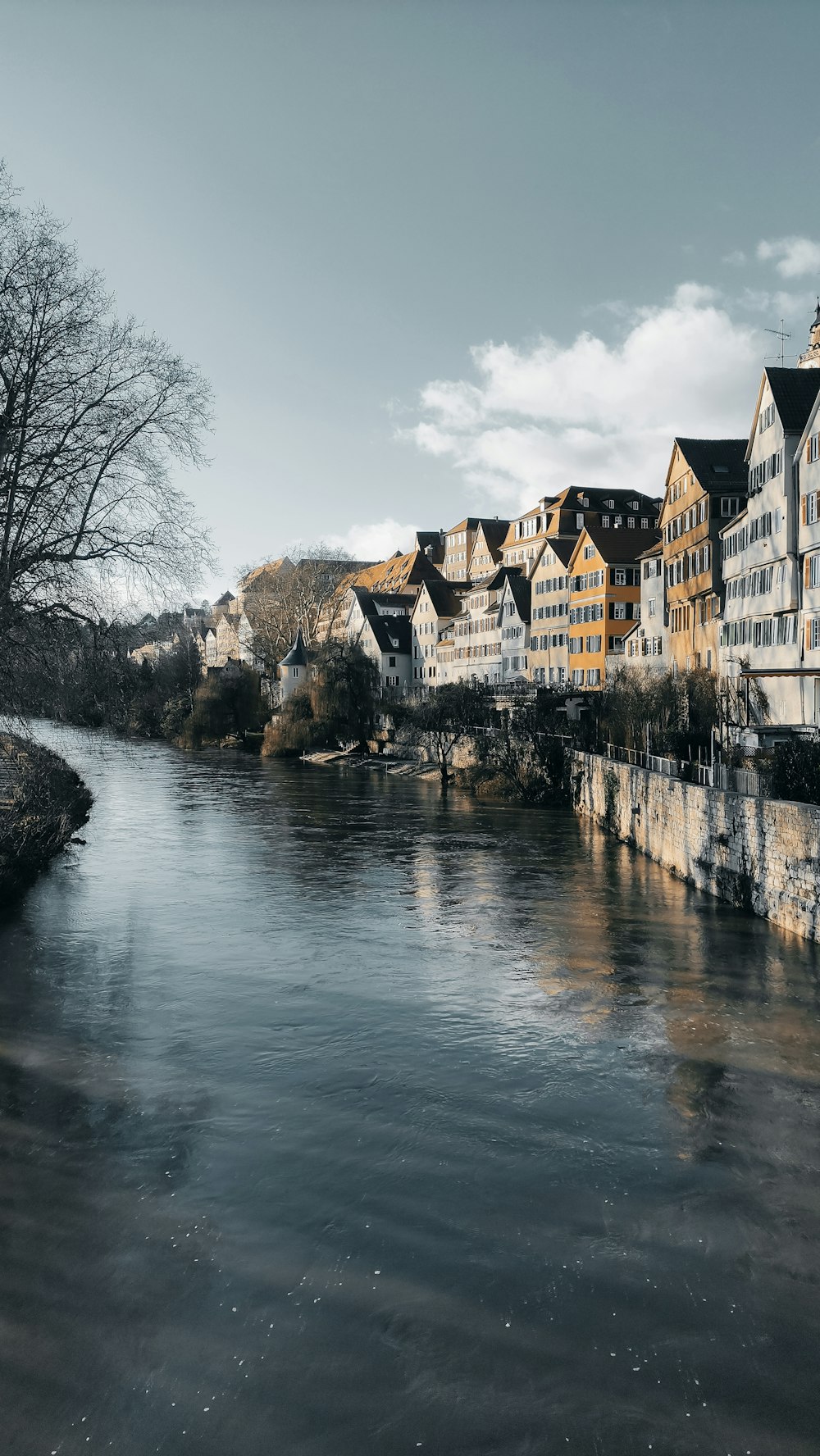 a river running through a city next to tall buildings