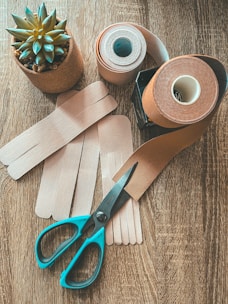 Hands preparing a simple first aid kit with bandages and herbs.