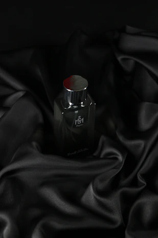 Premium car fabric spray bottle with oriental spice and floral notes, set against a dark wood background.