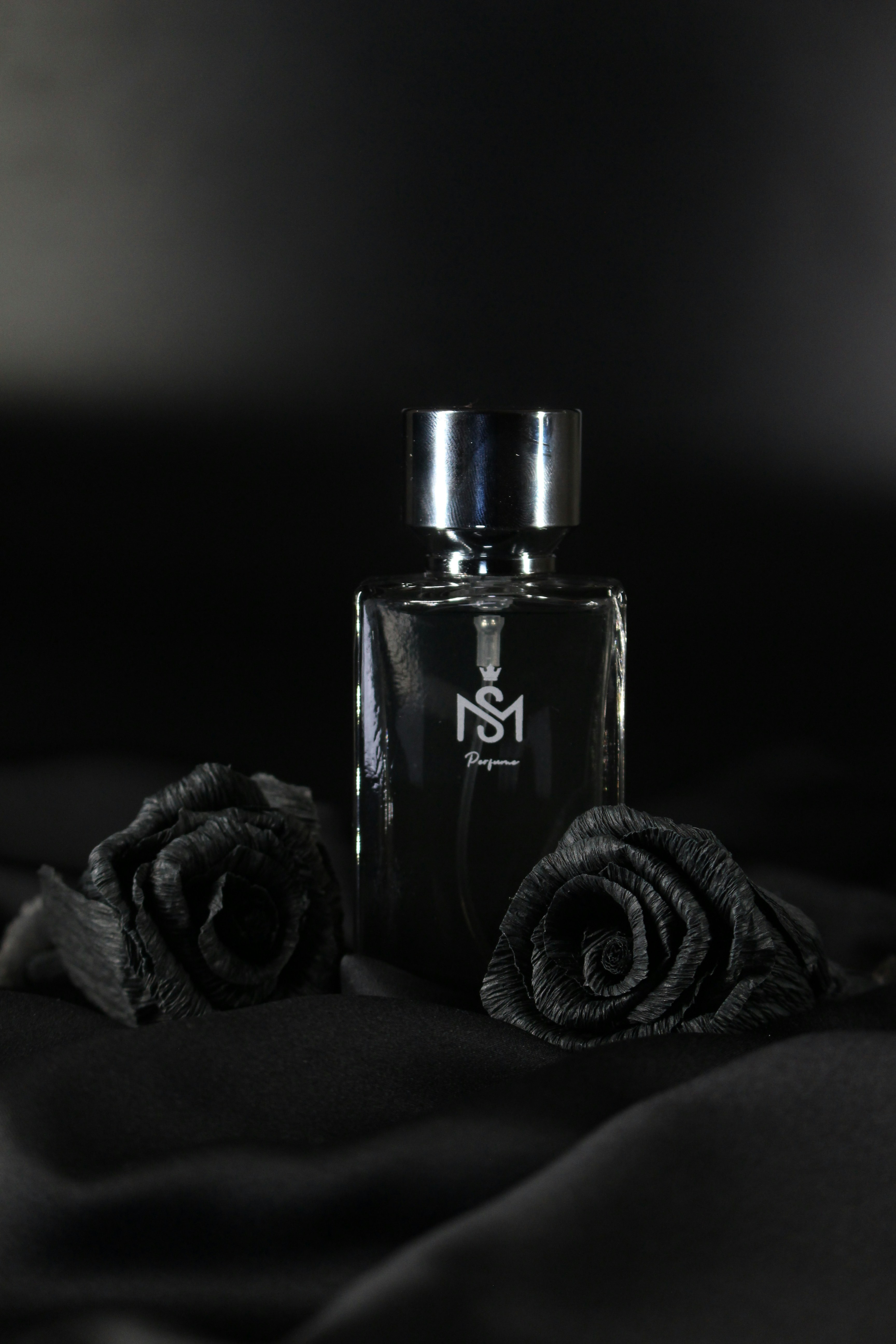 A bottle of perfume sitting on top of a bed photo Free Perfume Image