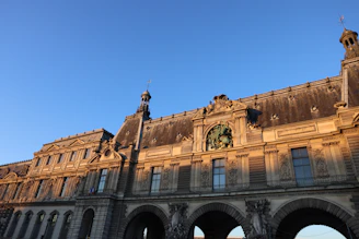 An aged stone building bathed in golden light, symbolizing enduring cultural heritage.
